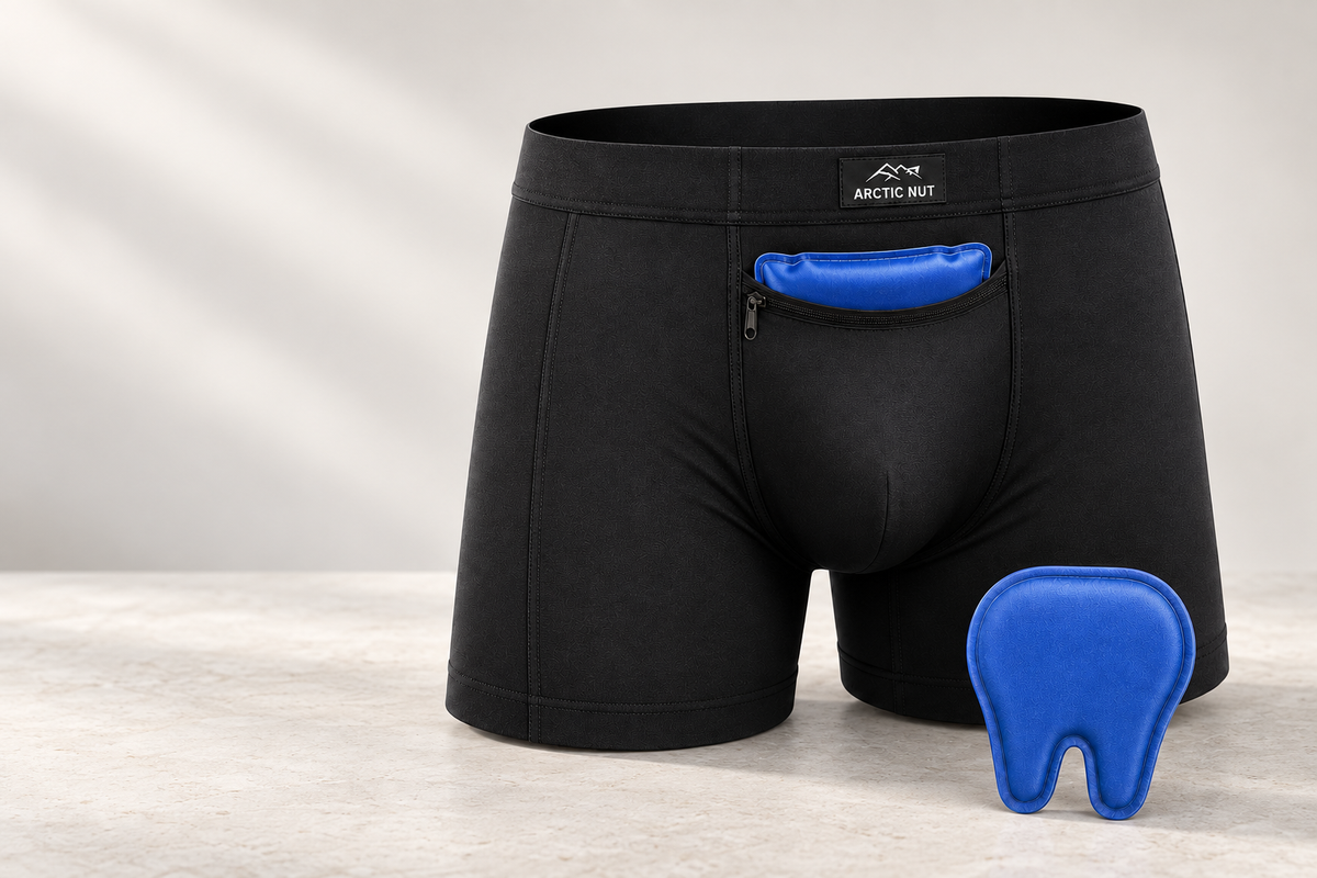 Black Arctic Nut Cooling Brief with its two blue reusable gel packs on pale stone