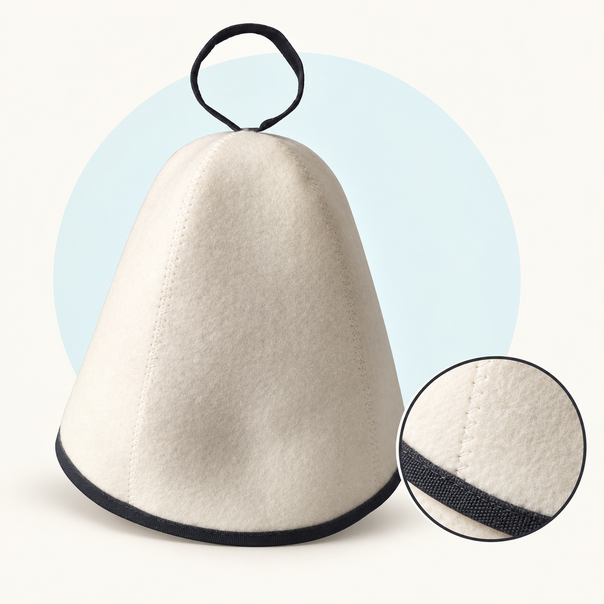 Product study of the white felt Banya Hat with black edge binding and top loop, with magnified felt and seam detail