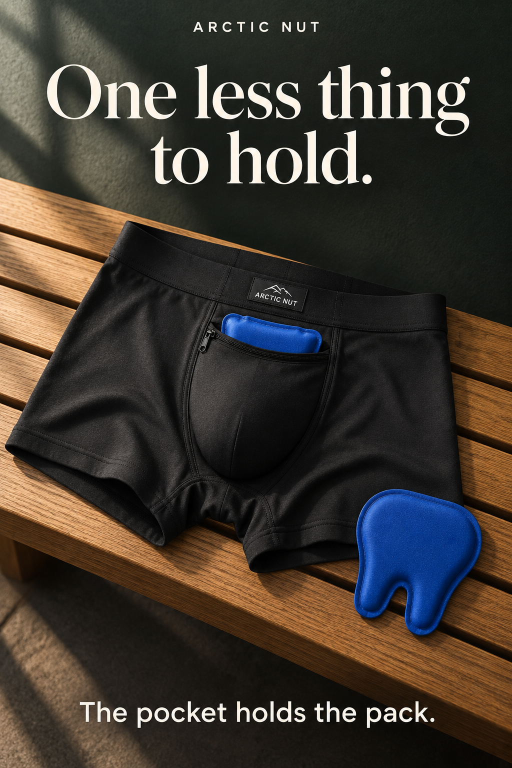 One less thing to hold. The pocket holds the pack. A tall editorial illustration shows the black Arctic Nut Cooling Brief on an oak bench, with one blue pack partly in its pocket and one spare beside it.