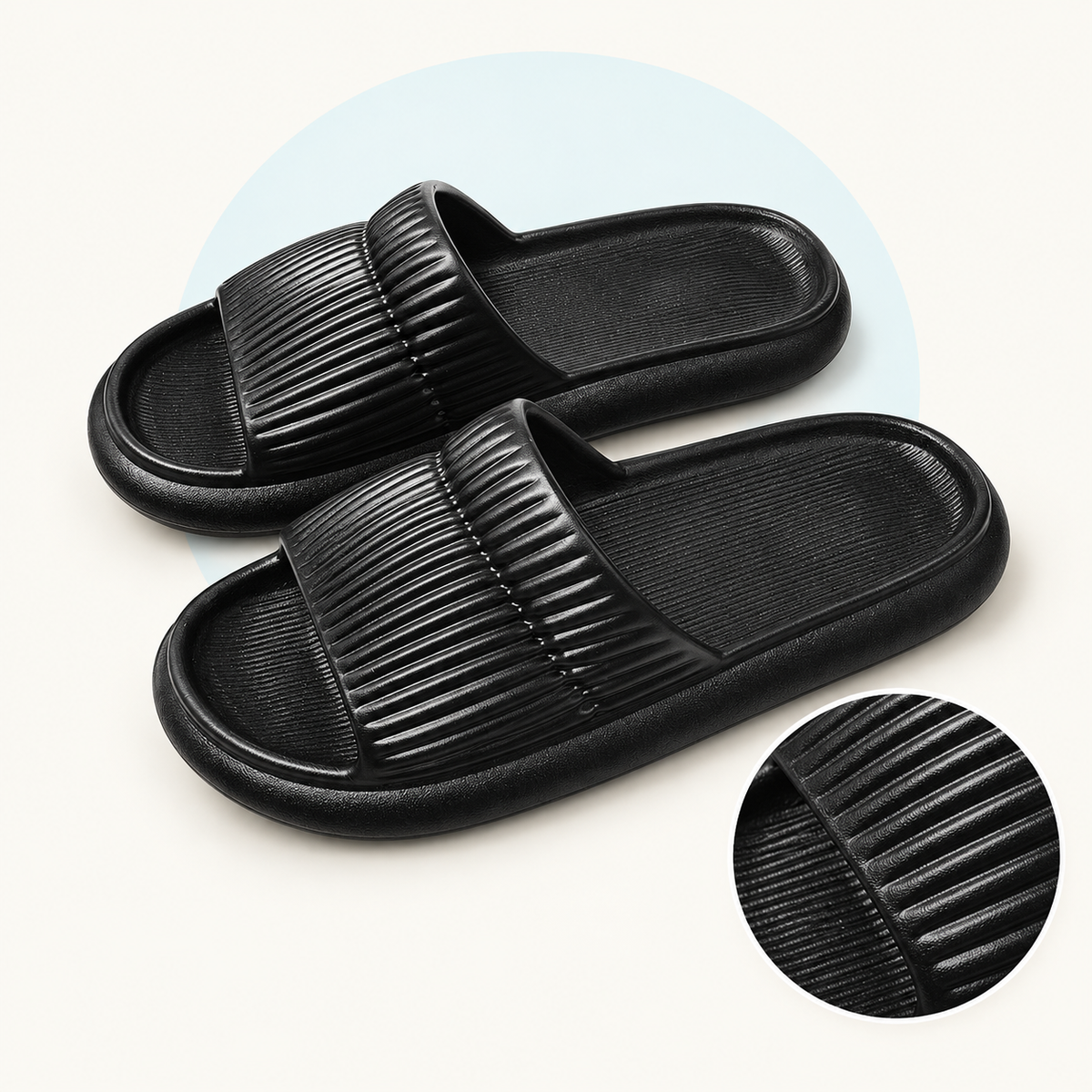 Product study of a pair of black EVA Shower Slides with striped upper bands, with magnified upper and footbed texture