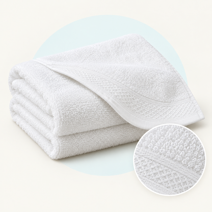 Product study of one folded white cotton bath towel, with magnified terry loop and woven border detail