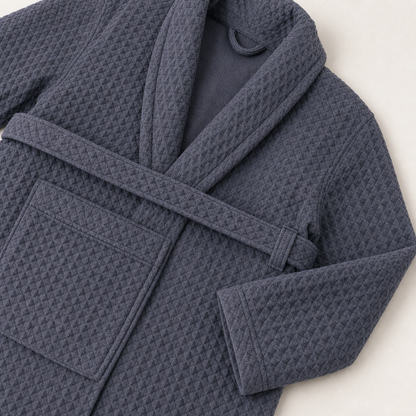 Close-up of Gray waffle robe construction showing shawl collar edge, self belt, belt loop, patch pocket, and sleeve cuff