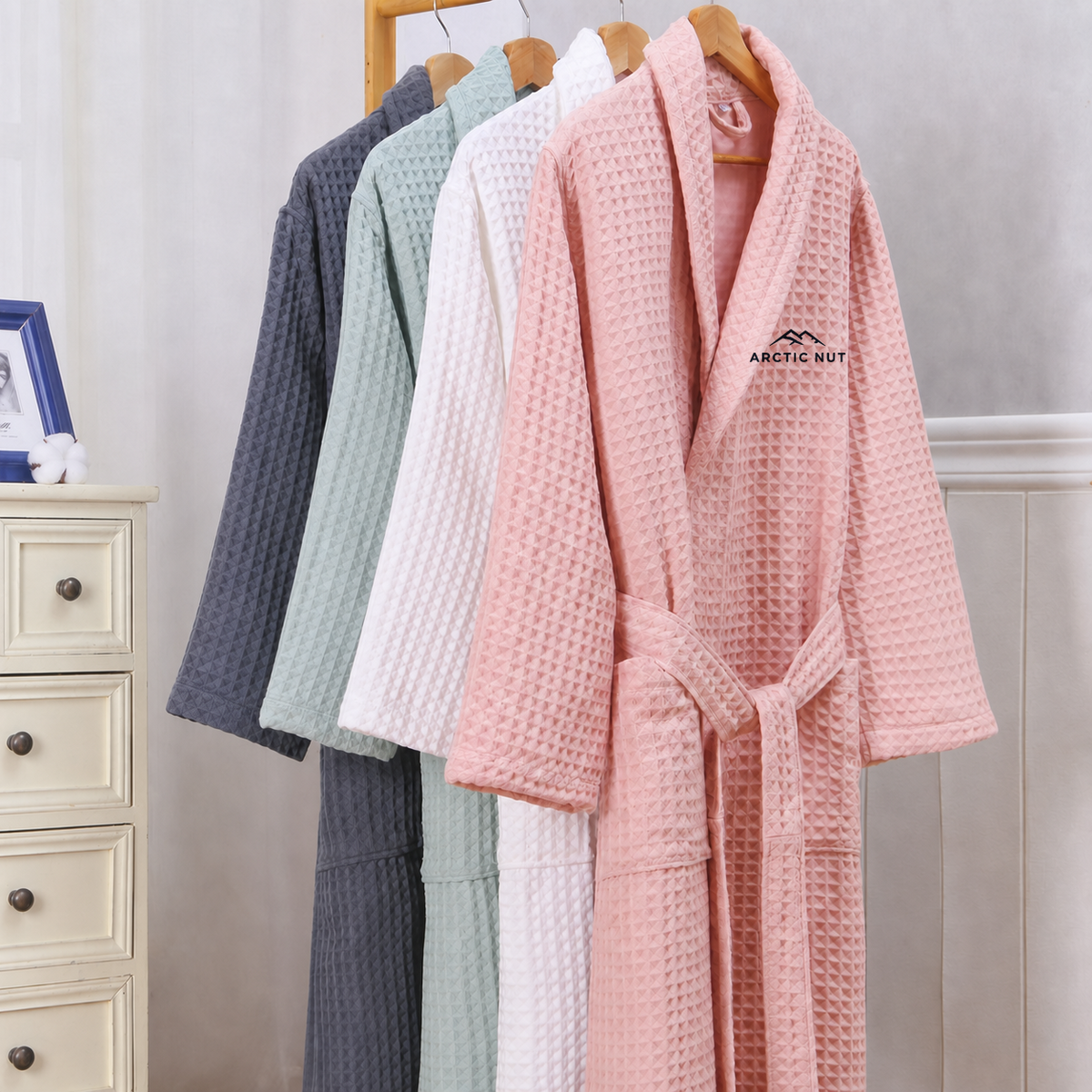Gray, Green, White, and Pink Arctic Nut waffle robes hanging side by side
