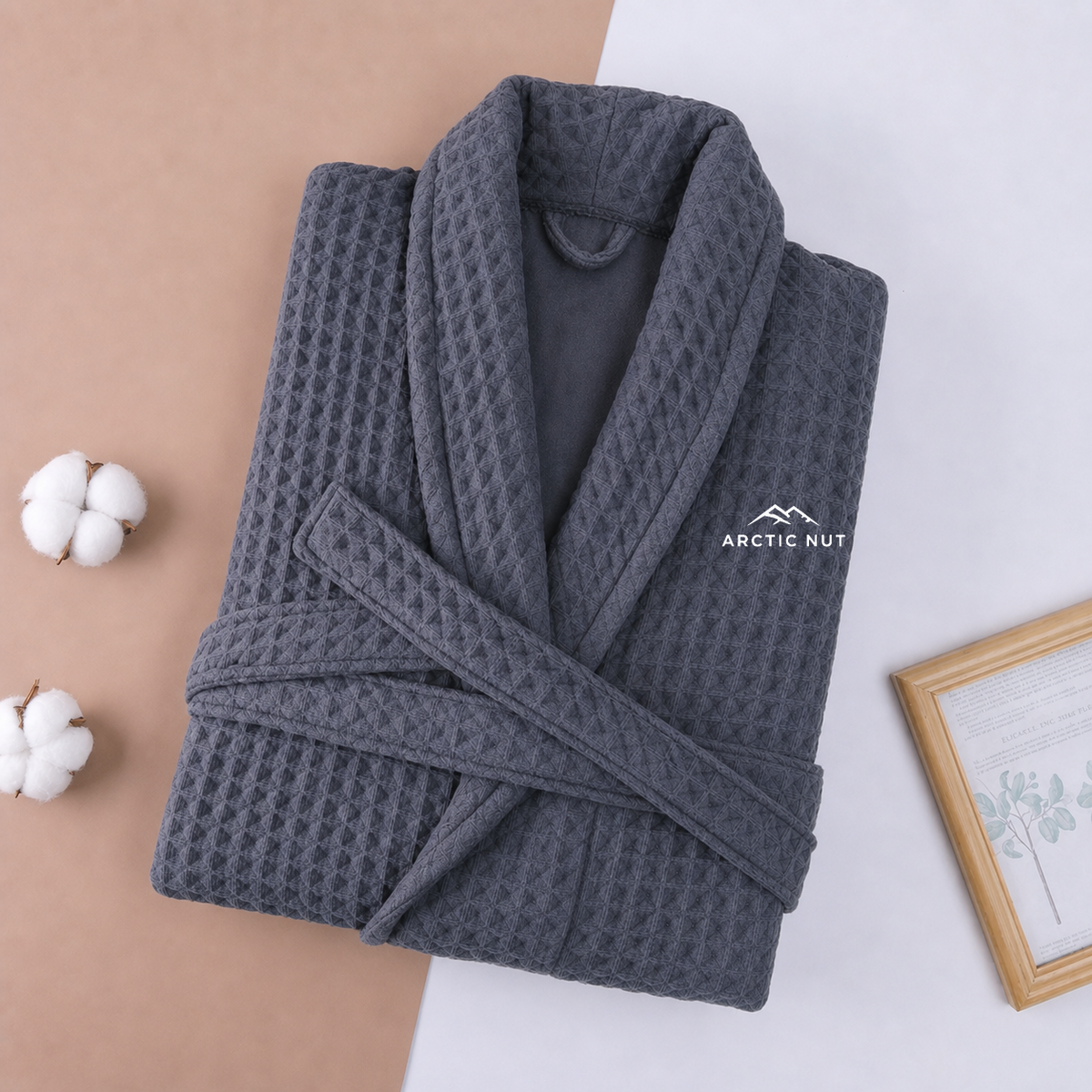 Folded Gray Arctic Nut waffle robe with shawl collar, self belt, and chest logo