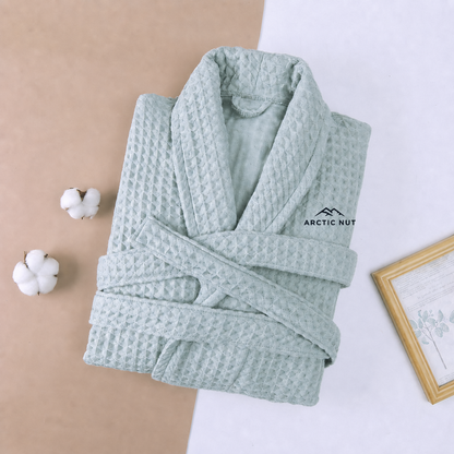 Folded Green Arctic Nut waffle robe with shawl collar, self belt, and chest logo